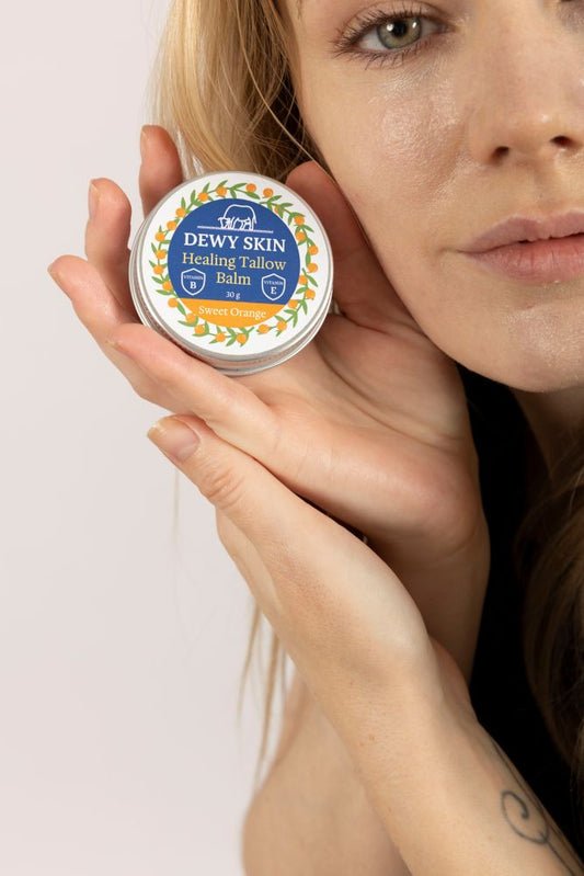 woman showing Dewy Skin Natural healing tallow balm sweet orange