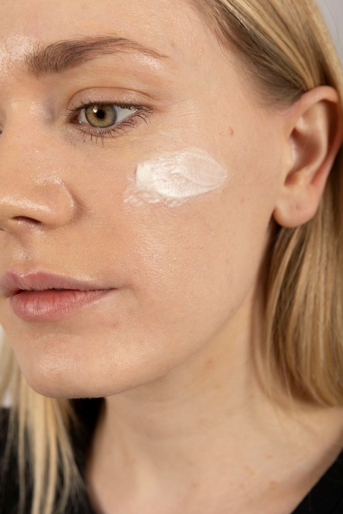 Woman applying Dewy Skin Natural Healing Tallow Unscented Balm on face